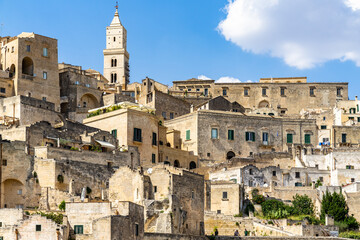 Typical buildings and houses of Sasso Caveoso district in Matera, with the bell tower of Matera cathedral on the top, Basilicata, Italy
