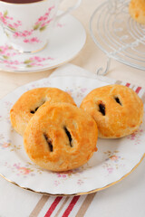 Eccles cakes a small round pastry filled with raisins originating from the town of Eccles in Lancashire England