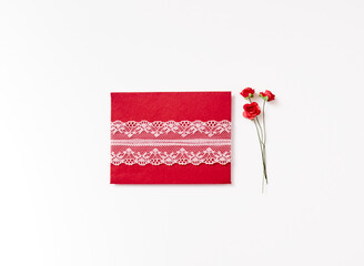Isolated paper envelope with lace and a roze on the white background with copy space © Kulbabka
