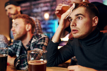 Group of people together indoors in the pub have fun at weekend time