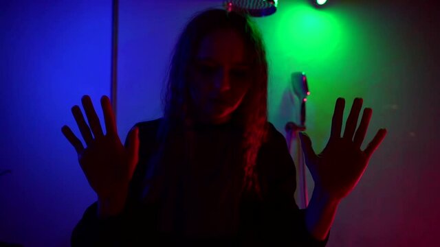 extrasensory strange woman is moving slowly in darkness, silhouette in apartment