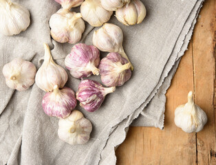 bunch of fresh garlic on a gray linen napkin