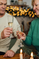 Happy elderly couple celebrating wedding anniversary. 60s happy retirement. Valentines seniors day. Champagne date