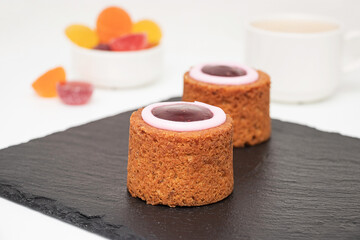 Runeberg Cakes (Runebergin Torttu) - traditional Finnish homemade pastry on a slate board, close-up. Runeberg day.