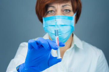 Doctor with a syringe for vaccination. COVID 19. Close-up. Virus protection.