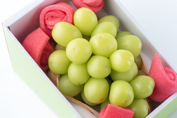 Beautiful boxed Shine Muscat green grape isolated on white background.