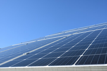 Solar panels against blue sky background.Against The Deep Blue Sky in suny weather