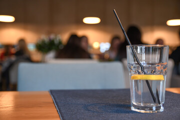 Water with lemon, drink, cocktail on the table in cafe with beautiful blurred background