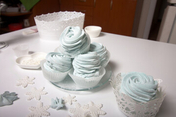 Homemade marshmallow sprinkled with icing sugar. Dessert lies on the table surface. Close-up shot.