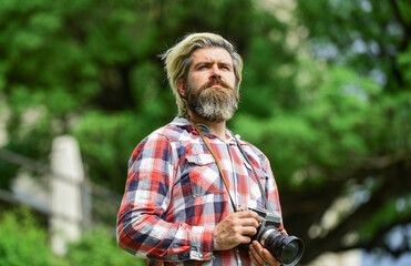 Professional photographer use vintage camera. Bearded man hipster take photo. Brutal stylish man with retro camera. Modern business. Photography business. Old technology. Journalist reporter
