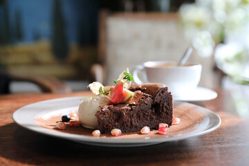 Chocolate cake with ice cream and coffee dessert on wood table