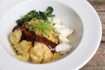 Shrimp dumpling noodles and crab meat on wood background