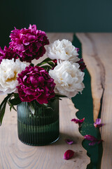 A bouquet of colorful peonies in a vase.