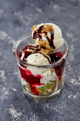 ice cream with fresh fruits and syrup