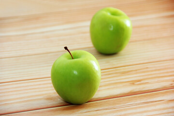 natural fresh green apples on wooden background