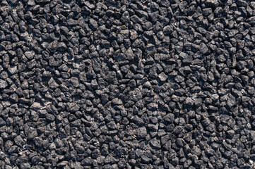 Gray small road stone background, dark gravel pebbles stone texture seamless texture, crushed granite