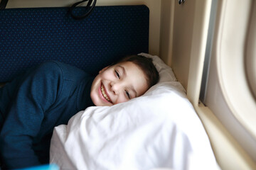 Child lying in train compartment