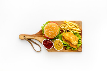 Delicious burgers with french fries and fried chicken. Flat lay, top view