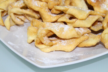 Brush cookies on a white plate on the table. Close-up. Background. Texture.