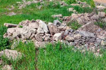 Stones on the grass . Pollution of nature with industrial waste