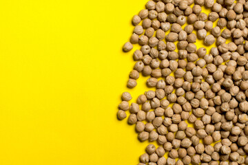 chickpea seeds on a yellow background.