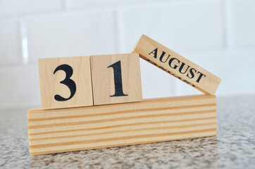 August 31, Cover design with number cube on a white background and granite table.