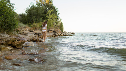 beautiful girl walking by the sea
