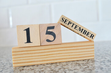 September 15, Cover design with number cube on a white background and granite table.