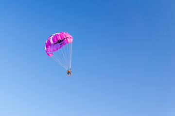 parasailing people under a parachute hanging in the air in summer. fun. feelings, family, travel, vacation. copyspace