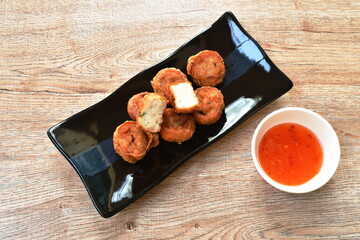 deep fried mashed crab meat and pork roll Chinese food on plate dipping sweet plum sauce