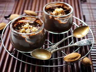 Chocolate mousse with almonds on wooden background
