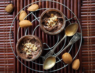 Chocolate mousse with almonds on wooden background
