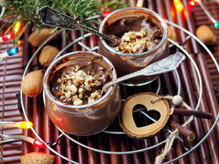 Chocolate mousse with almonds on wooden background
