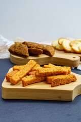 brown toast crackers croutons on a wooden board space for copying text, no waste. vertical photo