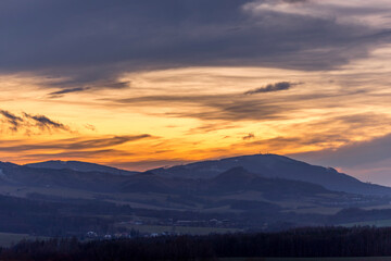 Colorful gold red sunset over Beskydy landscape and surrounding nature.