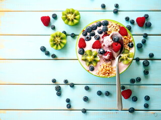 Naklejka na ściany i meble Healthy breakfast - the bowl of oat granola with yogurt, fresh raspberries, blueberries and nuts 