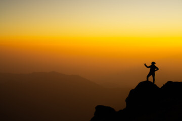 A young woman expressing her emotions after reaching the summit