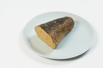 Stuffed carp fish. Jewish traditional whole gefilte fish cut served on plate isolated on white background. Minced fish fillet with vegetables in fish skin backed in oven. Dish isolated on white 
