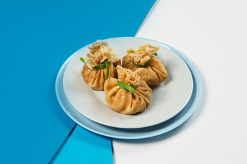 Side view of Holiday Russian starter dish blini. Traditional crepes appetizer with fresh spring onion scallions. Delicious new year Christmas dish. Isolated thin pancakes served on blue background
