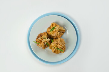 Top view of Holiday Russian starter dish blini with minced meat inside. Traditional crepes appetizer with fresh spring onion scallions. Delicious new year Christmas dish. Russian thin pancakes 
