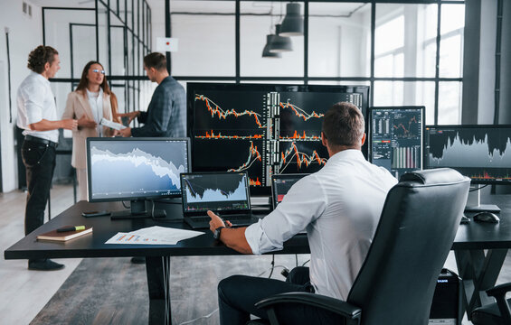 Ordinary Office Day. Team Of Stockbrokers Works In Indoors With Many Display Screens