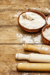 Ingredients for baking bread: bowls of flour and rolling pins