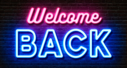 Neon sign on a brick wall - Welcome back