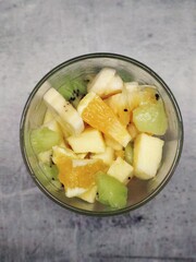 Exotic fruit salad in a glass glass. Vegan healthy food