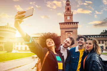 Group of four people diverse multiethnic tourist having fun taking selfie