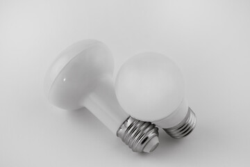 Two white LED bulbs on a white background.

