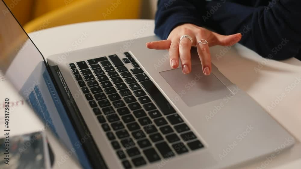 Poster freelancer's hand uses a touchpad in front of a laptop monitor. gesturing employees during a convers