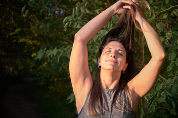 model grabbing her hair in the woods