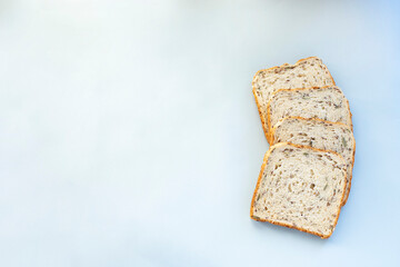 Cereal bread slices on light blue background. Image with copy space