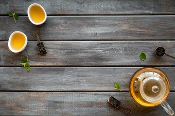Frame of hot and dry tea in teapot and cups. Tea ceremony concept